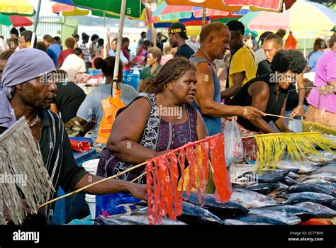 Trading fresh-caught seafood at the central market in Honiara ...