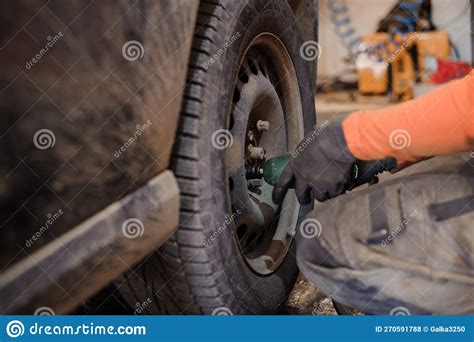 Replacement and Repair of Wheels and Shock Absorbers on a Car in a ...