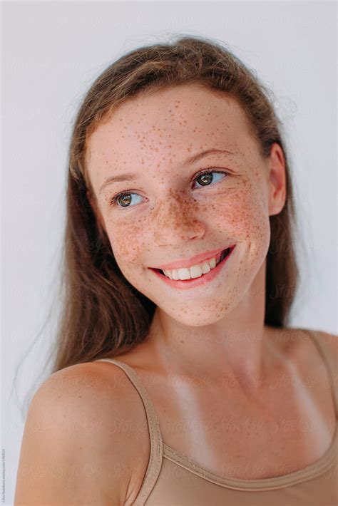 Beauty portrait of attractive smiling girl with freckles and long hair by Liliya Rodnikova ...