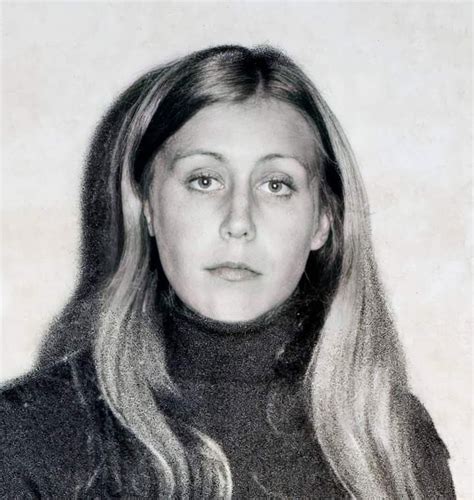 a black and white photo of a woman with long hair wearing a turtle neck sweater