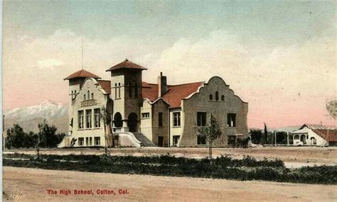 an old photo of a large building in the middle of a dirt field with ...