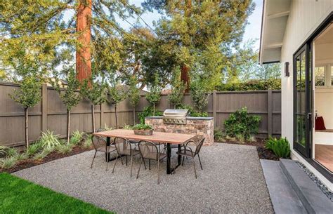 Cozy Backyard Gravel Patio with Outdoor Kitchen