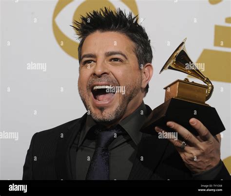 Luis Enrique holds the tropical latin album award for 'Ciclos' at the ...