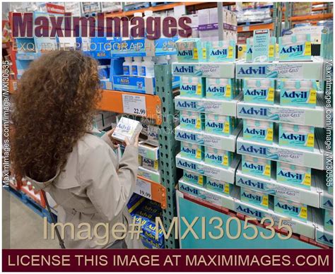 Photo of Woman picking Advil pain relief medications at Costco Wholesale warehouse store ...