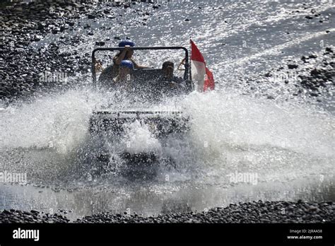 Offroad car brings tourists passing Kalikuning river in Sleman, Yogyakarta, Indonesia. This ...