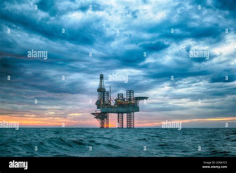 Oil rig at sunset time Stock Photo - Alamy