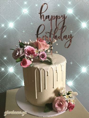 a birthday cake decorated with flowers and the words happy birthday written on top in cursive ...