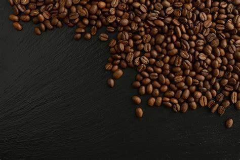 Premium Photo | Roasted coffee beans on a black background Beautiful ...