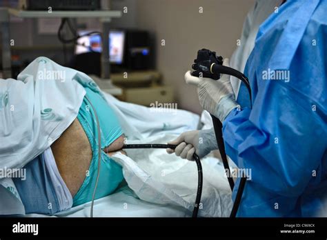 Doctor operating an endoscope to perform a colonoscopy examination ...