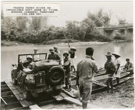 Troops ferry the river on an improvised raft made by tying bancas ...