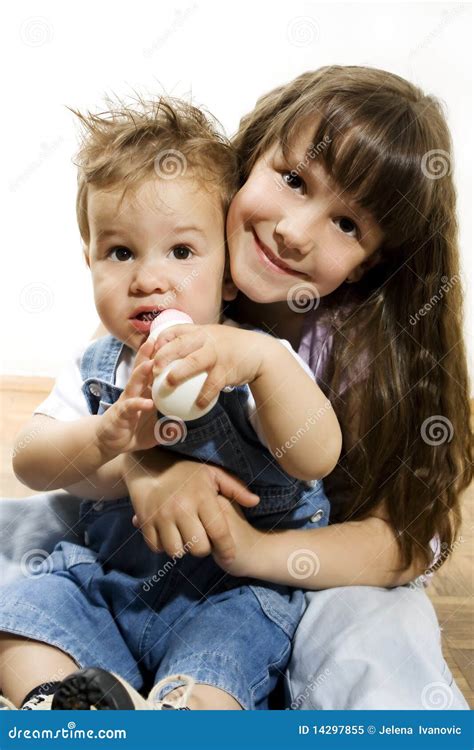 Little girl holding baby stock image. Image of child - 14297855