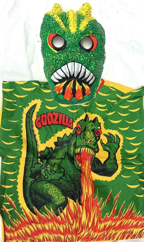 a green t - shirt with an image of godzilla on it