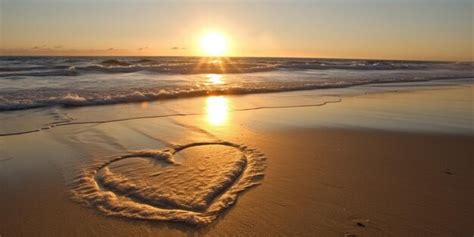 Premium Photo | Beach at sunset with heart drawn in the sand