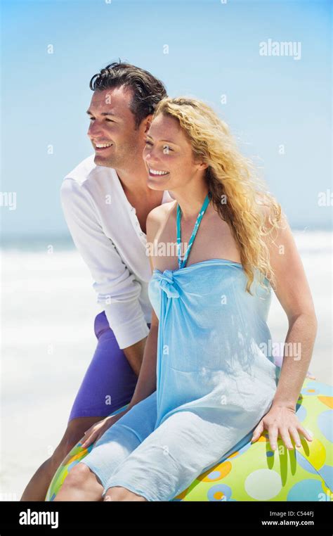 Couple smiling on the beach Stock Photo - Alamy