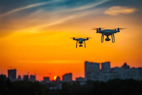 Two Drones Flying At Sunset - Coverdrone