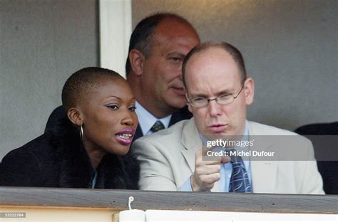 Prince Albert of Monaco chats with Nicole Coste as they watch a match ...