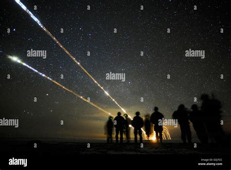 Streaks of tracer rounds light up the night sky during close air support combat training Joint ...