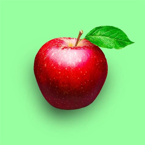 Premium Photo | A red apple with a green leaf on it