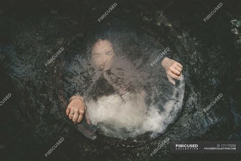 Girl underwater in well holding edges — alone, fashionable - Stock ...