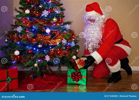 Santa Claus Delivering Presents Under The Tree. Royalty Free Stock ...