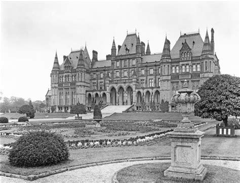 an old photo of a large building in the middle of a park with trees and ...