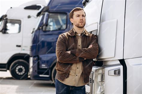 Premium Photo | Truck driver standing by his lorry