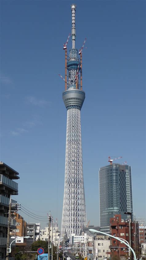 a very tall building with a sky scraper in the middle of it's side