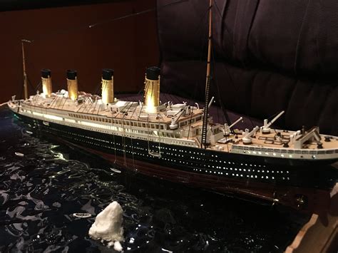 a model of a large ship in the water with icebergs floating around it