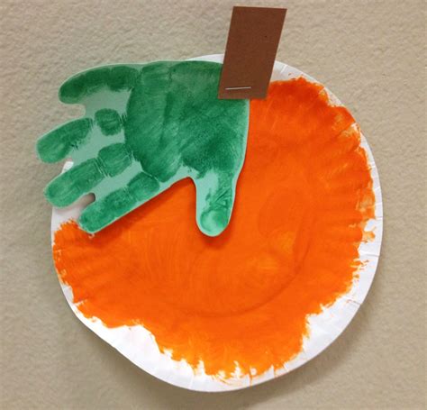 Painted orange pumpkin with green ink pad handprint | Halloween crafts ...