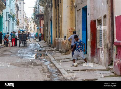 Havana, Cuba - April 12, 2023: People out and about on dirty damage ...