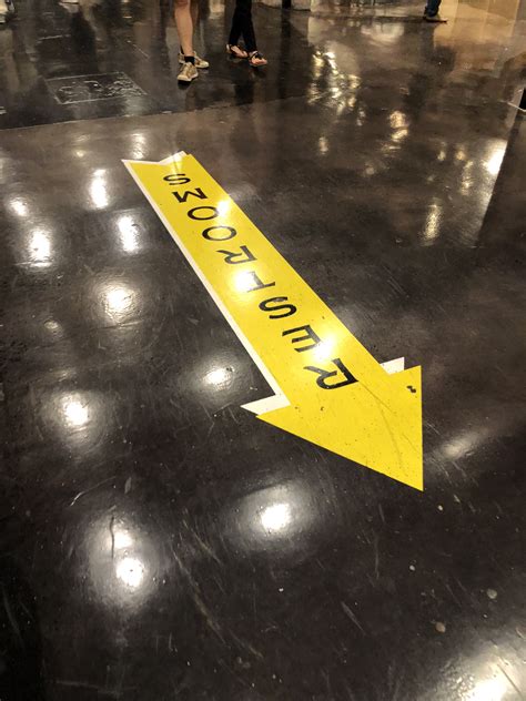 Directional sign on floor at Chelsea Market | Directional signs, Chelsea market, Flooring