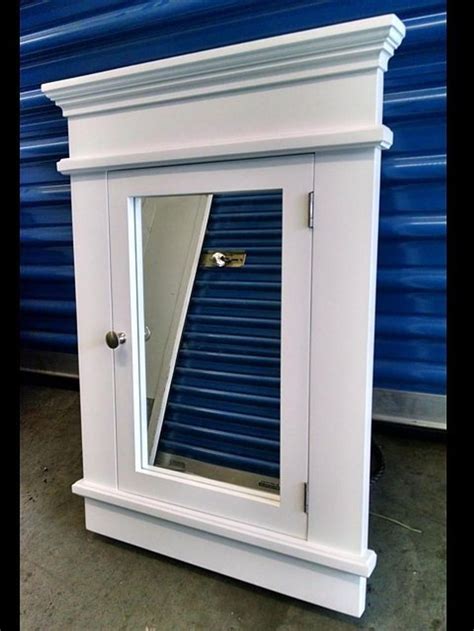 a white cabinet with a mirror on top