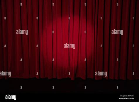 Spotlight on stage curtain Stock Photo - Alamy