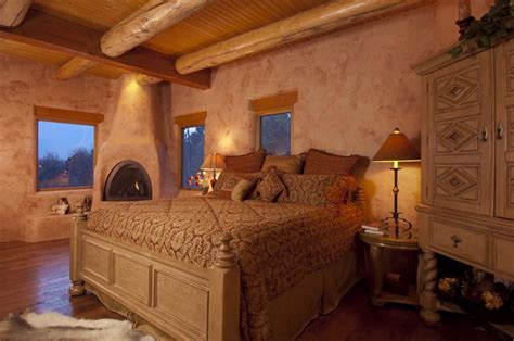 Santa Fe inspired master bedroom with pine beams, hand scraped floors, hand plastered walls, and ...