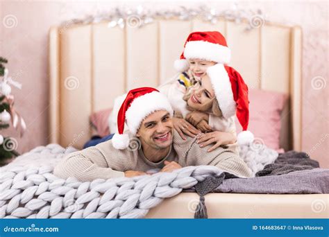 Happy Family Mother Father and Kids on Christmas Morning in Bed in ...