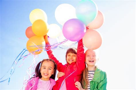 Happy kids with balloons stock image. Image of birthday - 94619883