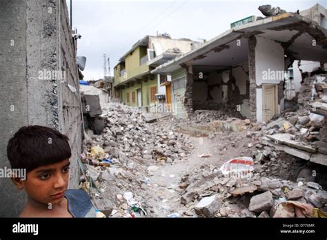 A young boy in a street destroyed by the Kashmir earthquake in October 2005 in Muzaffarabad ...