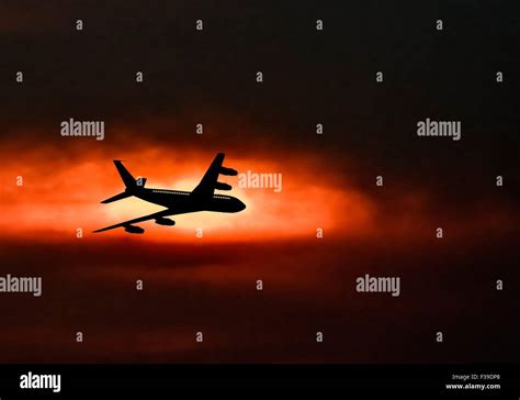 Passenger jet airplane silhouette in blurred sunset sky. Vector ...