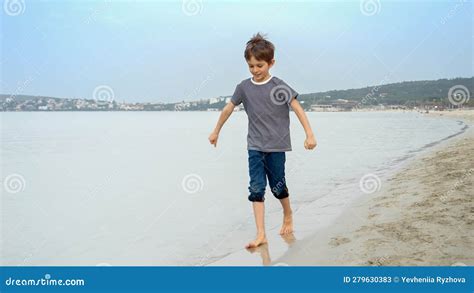 Barefoot Boy Runs on a Sandy Beach, Splashing Water, Carefree Spirit of Childhood, Travel, and ...