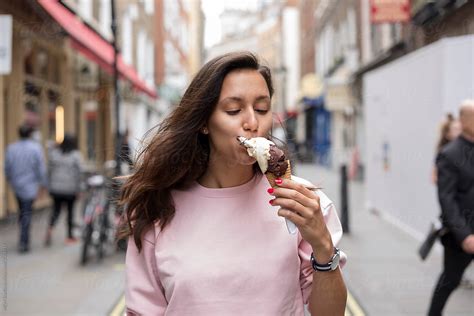 "Beautiful Young Woman Eating Ice Cream In Covent Garden, London" by ...