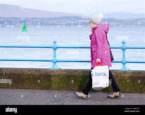 Greenock, Scotland / UK - February 20th 2020: People walking along coastal path during Storm ...