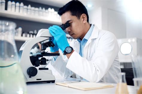 Premium Photo | Microscope asian man in laboratory for healthcare ...