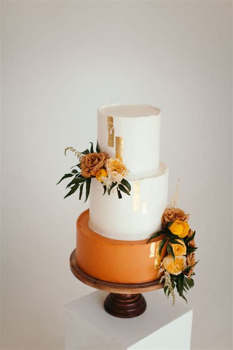 Modern white and terracotta wedding cake, gold leaf accents