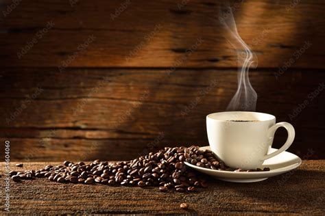 Coffee cup and coffee beans on old wooden background Stock Photo ...