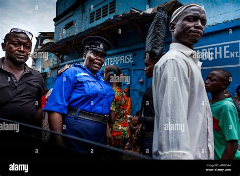 Yongoro, Sierra Leone - June 01, 2013: West Africa, unknown people with policeman, city streets ...