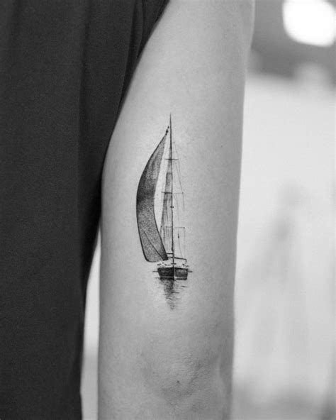 Micro-realistic style sailboat tattoo done on the