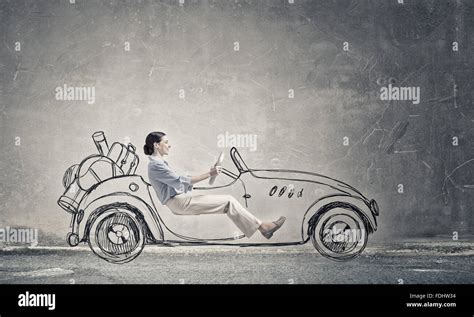 Young humorous woman driving drawn funny car Stock Photo - Alamy