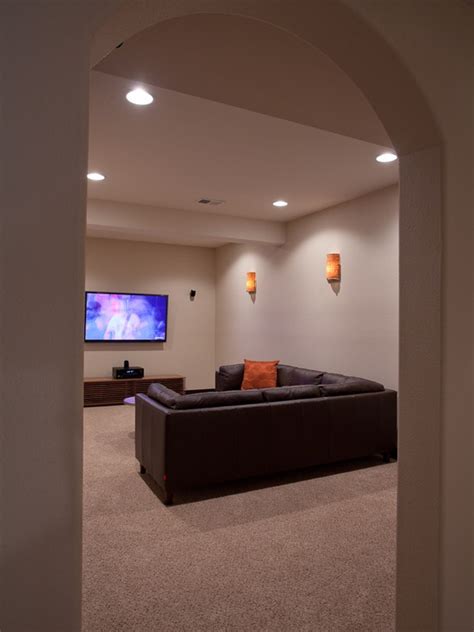 a living room with couches and a flat screen tv on the wall in it