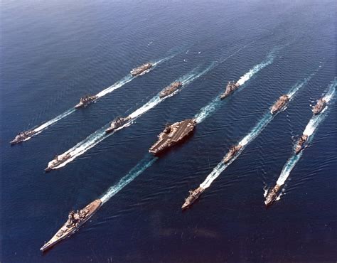 An Iowa class battleship leads a battle group at sea in the 1980s [5637x4414] : WarshipPorn