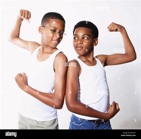 Mixed race boys flexing their muscles Stock Photo - Alamy